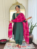 Bottle green glam with a vibrant rani pink dupatta touch