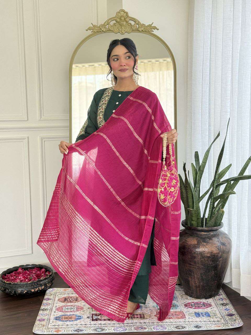Bottle green glam with a vibrant rani pink dupatta touch